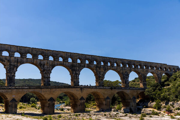 PROVENCE, FRANCE - JUNE 18, 2018: Pont du Gard (bridge across Gard) ancient Roman aqueduct across Gardon River in  Provence, France