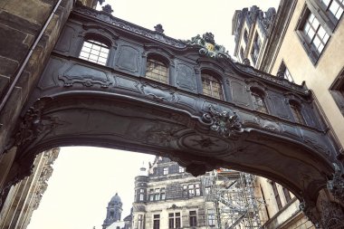 Low angle view of old black arch and dresden cathedral in Dresden, Germany clipart