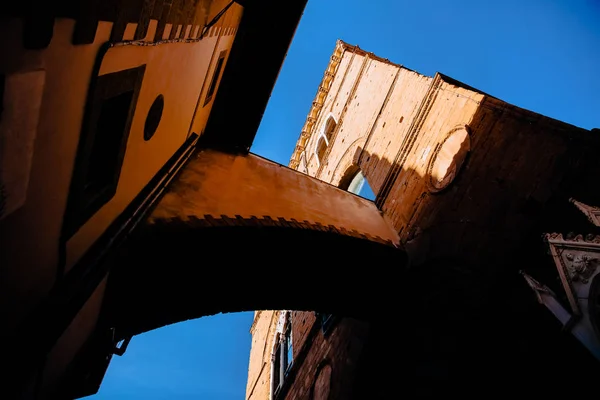 Vue à angle bas de belle ancienne arche et tour contre ciel bleu, florence, italie — Photo de stock