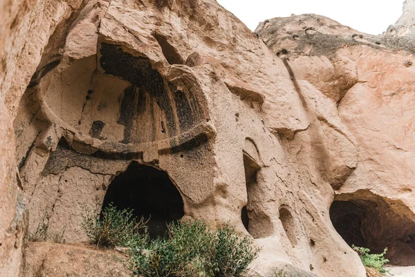 Low angle view of scenic caves in sandstone at famous cappadocia, turkey — Stock Photo