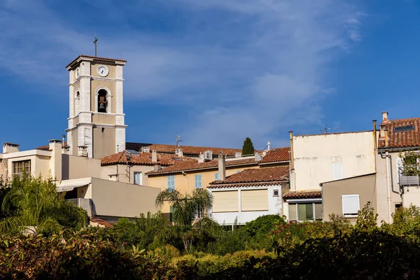 Old clock tower and traditional houses in french town — Stock Photo