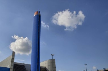 Turin, Gerbido, Piedmont Italy 29 May 2018. The waste-to-energy plant of the company TRM-IREN GROUP. Shot showing the 120-meter high chimney painted in deep blue. Visible integrated panoramic lift. clipart