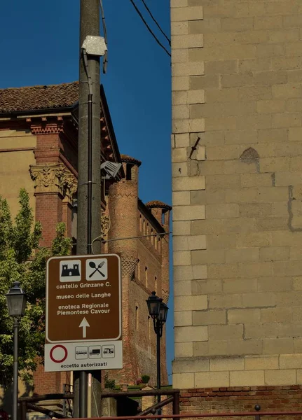 Grinzane Cavour, Piedmont, Italy. July 2018. Tourist information sign in the center of the country: highlights the presence of the castle and the Langhe museum and regional wine shop.