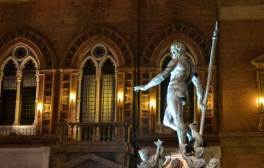 Bologna, Emilia Romagna, İtalya. Aralık 2018. Gece Neptün çeşme, Yılbaşı için, renkli ışıklar ile aydınlatılmış ve onu korumak için çitle çevrili olmuştur.