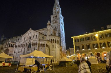 Modena, Emilia Romagna, İtalya. Aralık 2018. Piazza Maggiore'ye şehrin ortasıdır. Saat Kulesi ve Katedral Meydanı karakteristik unsurları vardır. Noel ışıkları karanlık yanar.