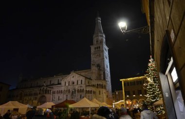 Modena, Emilia Romagna, İtalya. Aralık 2018. Piazza Maggiore'ye şehrin ortasıdır. Saat Kulesi ve Katedral Meydanı karakteristik unsurları vardır. Noel ışıkları karanlık yanar.