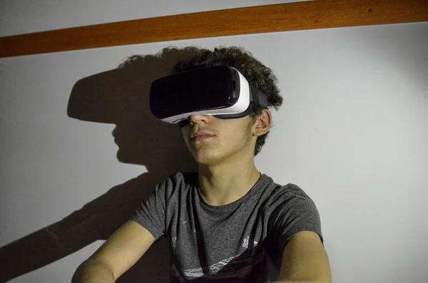 Un joven caucásico lleva el visor VR 360 en su habitación — Foto de Stock