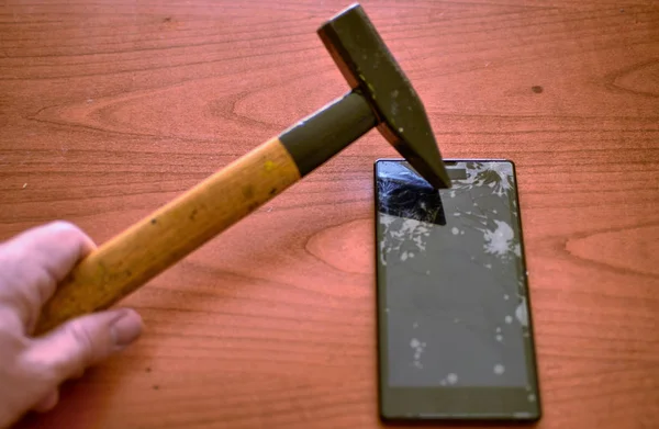 Кончик молотка попал в экран смартфона — стоковое фото
