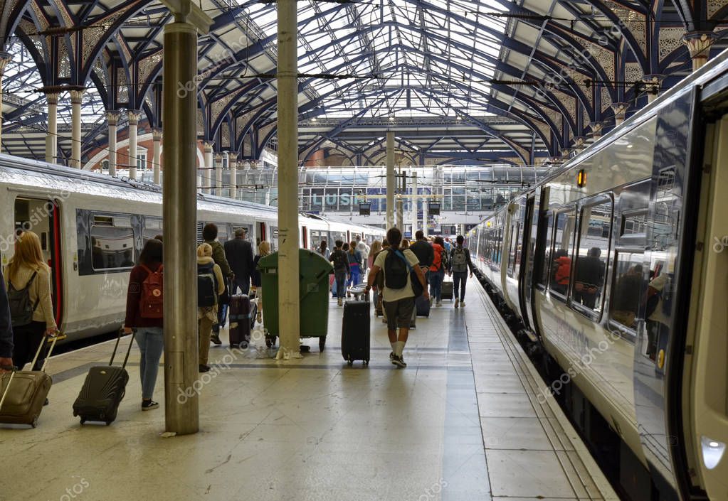 Liverpool street station, London United Kingdom, 14 June 2018. Passengers get off the trains and move towards the main hall. The glass canopy characterizes the interior of the station.