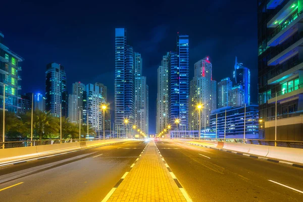 Modern buildings and illuminated road of Dubai UAE — Stock Photo, Image