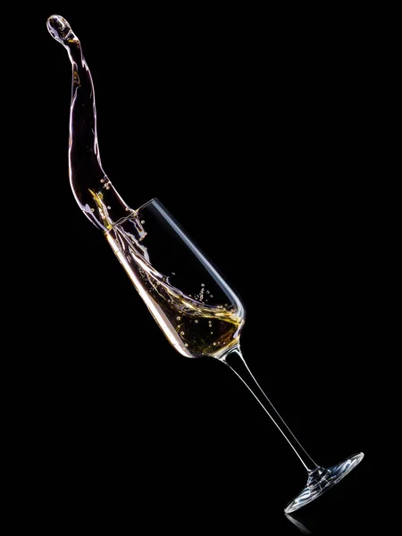 Glass for champagne with bubbles and splashes isolated on black background. — Stock Photo, Image