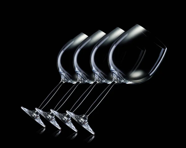 Set of empty glasses for red wine in a row isolated on black background. — Stock Photo, Image