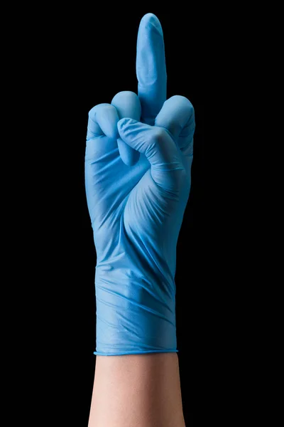 Doctors hand in medical gloves showing middle finger or fuck isolated on black — Stok Foto