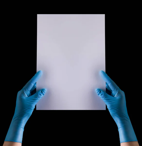 Doctors hand in sterile medical gloves holding banner isolated on black — Stock Photo, Image