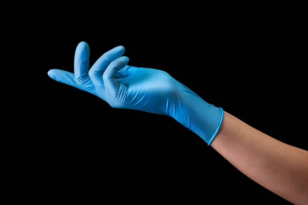 Doctors hand in medical gloves pointing by finger on side isolated on black — Stock Photo, Image