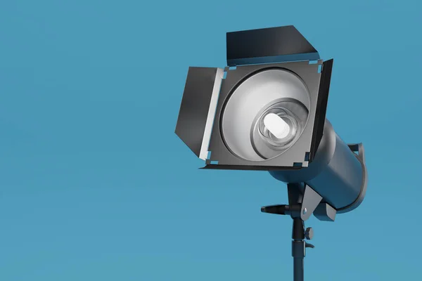 Photo studio lighting stands with flash and softbox on the blue background