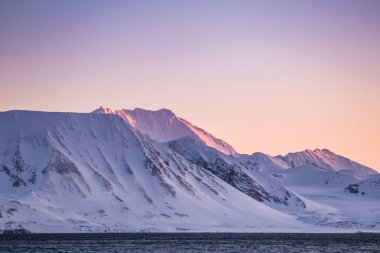 Dağlarda nefes kesici manzara Pastel renkli günbatımı