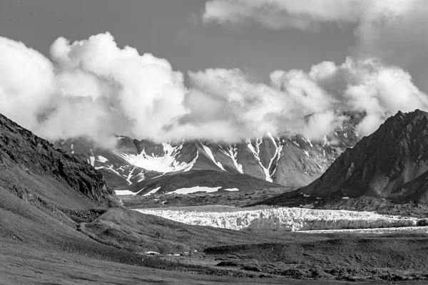 Breathtaking view on mountains with beautiful airy clouds