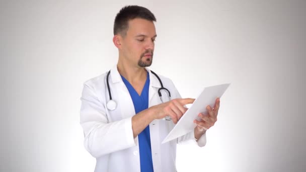 Мужчина врач читает медицинский документ, выписывает рецепт, портрет — стоковое видео