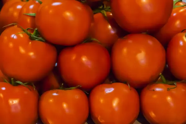 a pile of tomatoes on the market