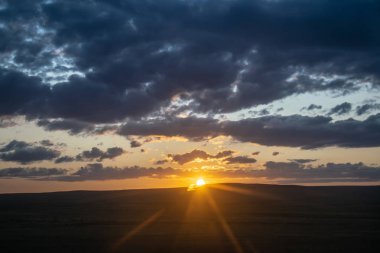 Kazakistan bozkırlarında güneşli gün batımı.