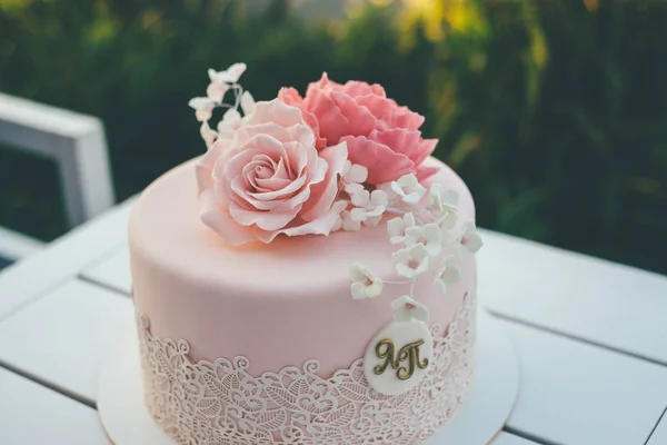 Geglazuurde roze bruidstaart op tafel — Stockfoto