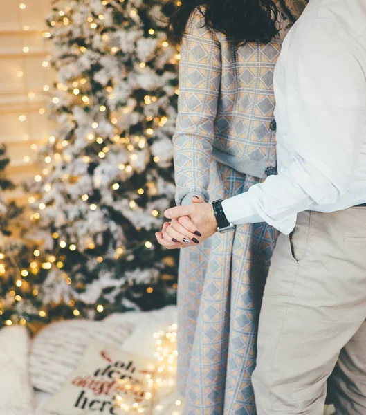 Couple of lovers dancing near the Christmas tree close up — Stockfoto