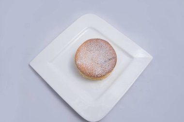 Bir plaka üzerinde bir Pan kek düşük kontrast Hero Shot, bir diyagonal 60 derecelik açı ile minimal Beyaz arka plan üzerinde