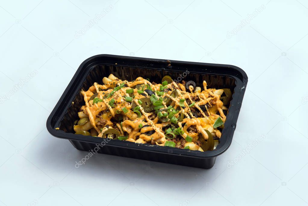 A high contrast Hero shot of a Take-Away Hot Loaded fries / chips with cheese, ground meat, olives, jalapeno, sauce & oregano, on a minimal white background with a 45 degree angle from zoomed out right diagonal perspective.