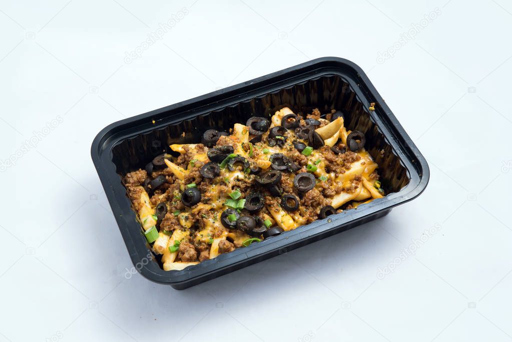 A high contrast Hero shot of a Take-Away Hot Loaded fries / chips with ground meat, olives, cheese, jalapeno, sauce & oregano, on a minimal white background with a 60 degree angle from zoomed out right diagonal perspective.