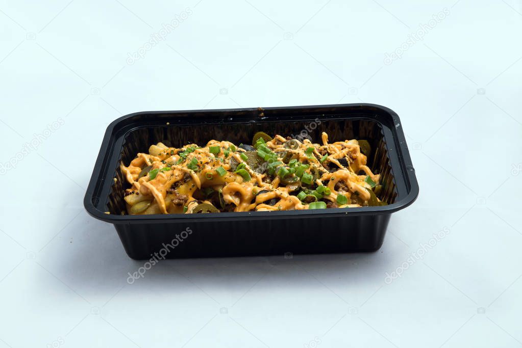 A high contrast Hero shot of a Take-Away Hot Loaded fries / chips with cheese, ground meat, olives, jalapeno, sauce & oregano, on a minimal white background with a 45 degree angle from zoomed out frontal perspective.
