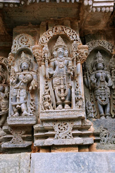 Lord Brahma merkezi ve diğer tanrılar, Kuzey duvarı, Kedareshwara Tapınağı, Halebidu, Karnataka, Hindistan tasvir eden süslü duvar paneli kabartma.