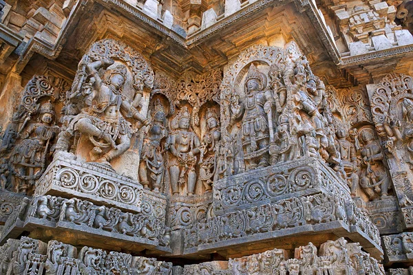 Sculptures west side walls. Shiva on the left and Vishnu on the right. Hoysaleshwara temple, Halebidu, Karnataka, India. view from West.