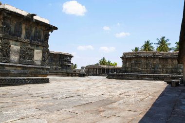 South West view of Chennakeshava temple complex, Belur, Karnataka, India. From Left, Ranganayaki temple wall, Mandapa of Soumyanayaki temple and Veeranarayana temple. clipart