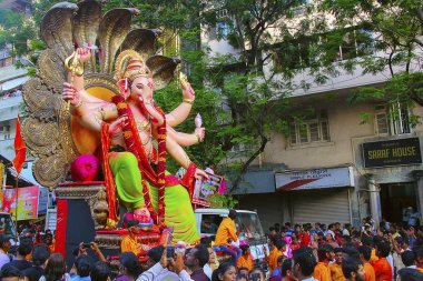 MUMBAI, INDIA, September 2017, People at Ganapati procession with huge Ganapati idols, carried on truck clipart