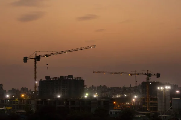 Construction work on building at night, India