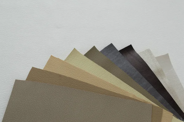 Leather sheet stack of gray and brown color shades on white background