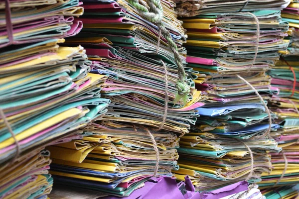 Files in different colors stacked up in office.