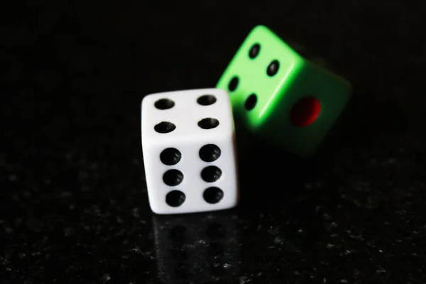 Two dice on a black background, game play. — Stock Photo, Image