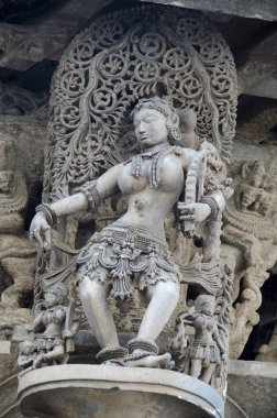 Carved sculptures on the outer wall of the Chennakeshava Temple complex, 12th-century Hindu temple dedicated to lord Vishnu, Belur, Karnataka, India clipart