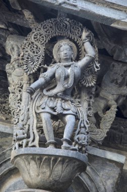 Carved sculptures on the outer wall of the Chennakeshava Temple complex, 12th-century Hindu temple dedicated to lord Vishnu, Belur, Karnataka, India clipart