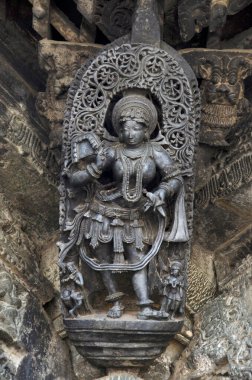 Carved sculptures on the outer wall of the Chennakeshava Temple complex, 12th-century Hindu temple dedicated to lord Vishnu, Belur, Karnataka, India clipart