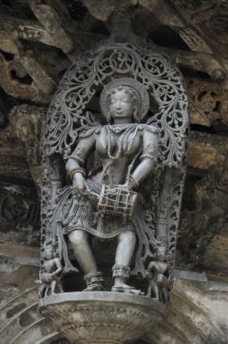 Carved sculptures on the outer wall of the Chennakeshava Temple complex, 12th-century Hindu temple dedicated to lord Vishnu, Belur, Karnataka, India clipart