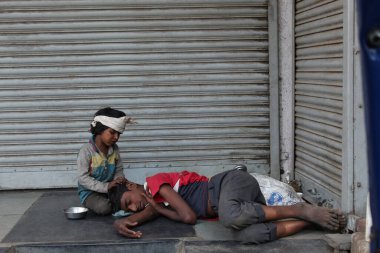 PUNE, MAHARASHTRA, March 2019, Street kids resting, Pune, Maharashtra clipart