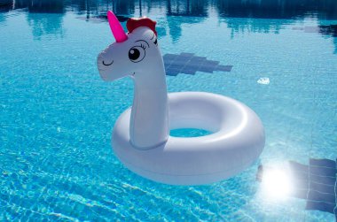 Tek boynuzlu at yüzmek tüp yüzme havuzunda yüzen 