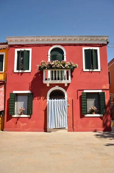 House with red wall. Colorful houses in Burano island near Venice, Italy. Colorful concept