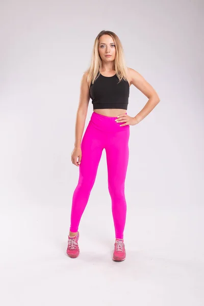 Fitness woman in sport style clothes. Attractive and sportive wo
