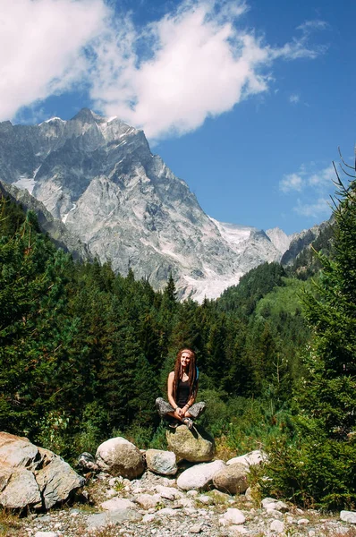 Woman tourist sitting on mountain in Svaneti in Georgia near Cha