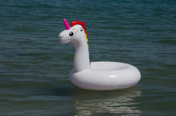 Unicorn inflatable float on the sea. Unicorn swim tube. — Stock Photo, Image