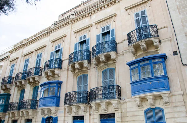 Facade of the house with blue maltese balconies in Valletta in M